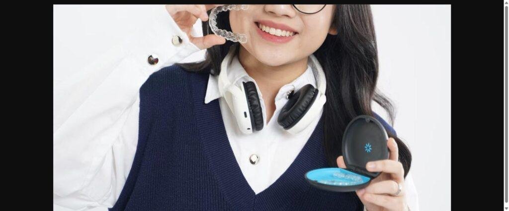 Smiling woman holding a clear Invisalign aligner and case in Vancouver