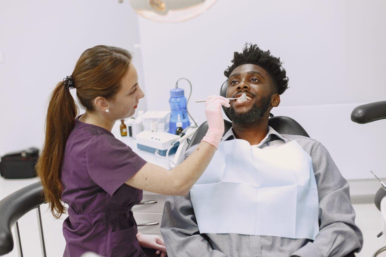 Dentist examining patient gums for bleeding in Kitsilano