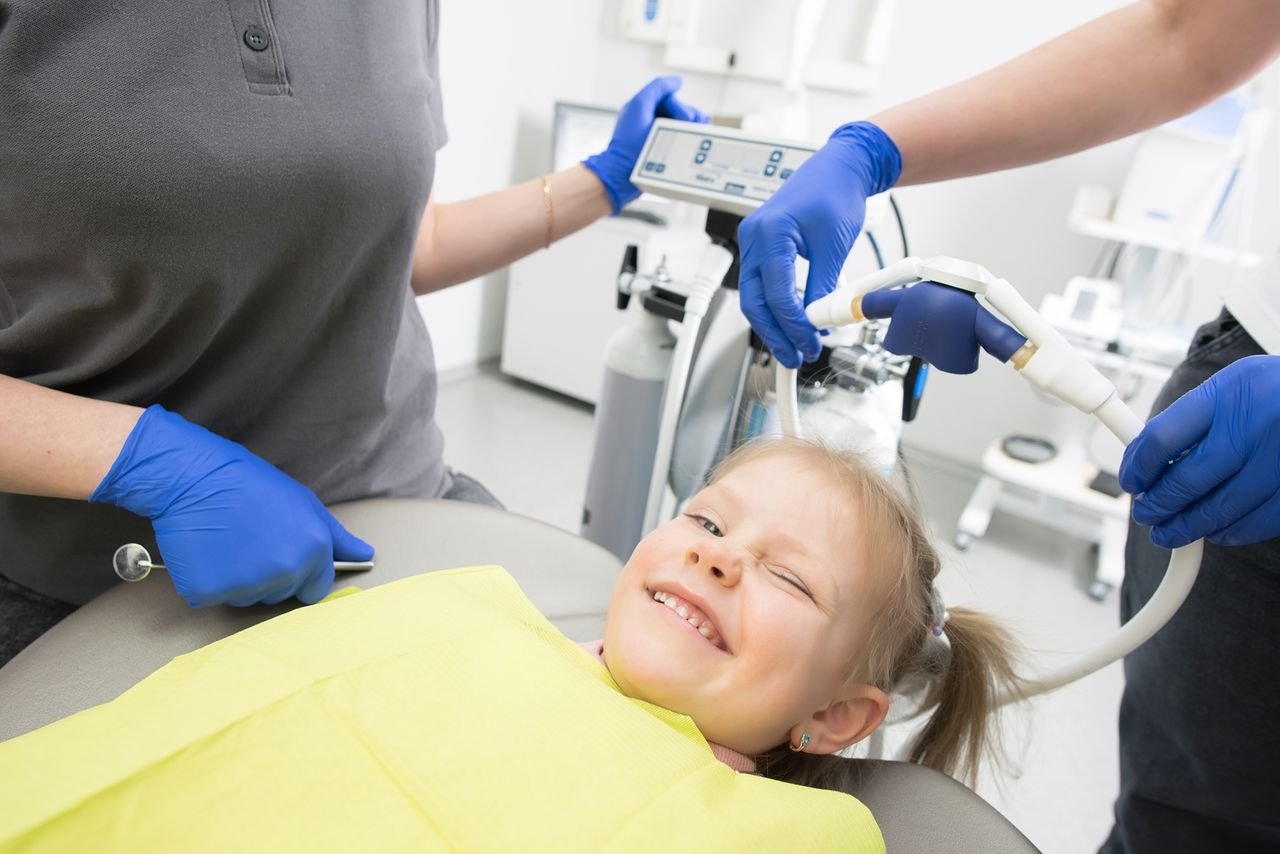 Young girl smiling in a dental chair