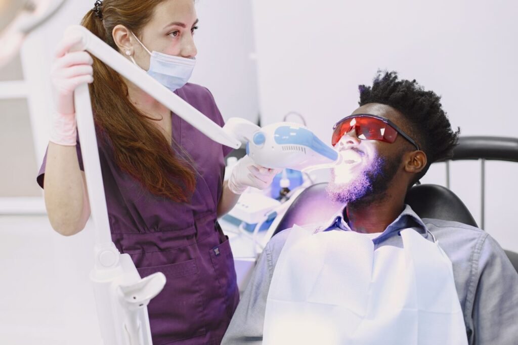 Dentist whitening a patient teeth in a Vancouver clinic