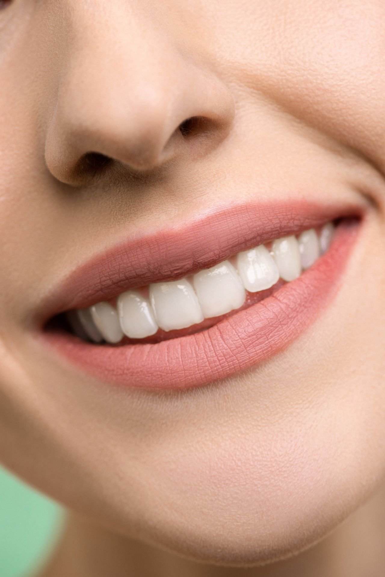 Woman smiling confidently after cosmetic dental treatment