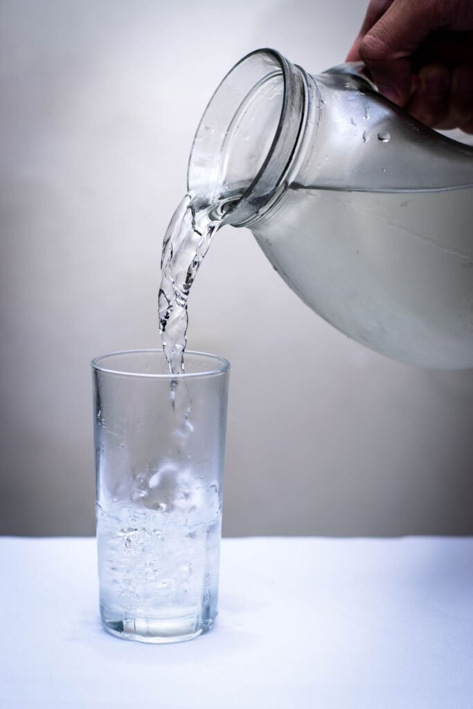 Water being poured into a glass to help relieve constant dry mouth